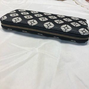 Black and white wallet with salmon color inside.